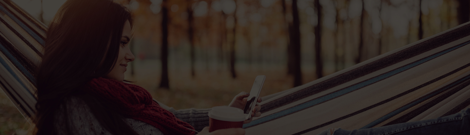 woman in hammock looking at phone